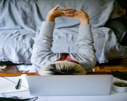 man stretching arms at home taking a break